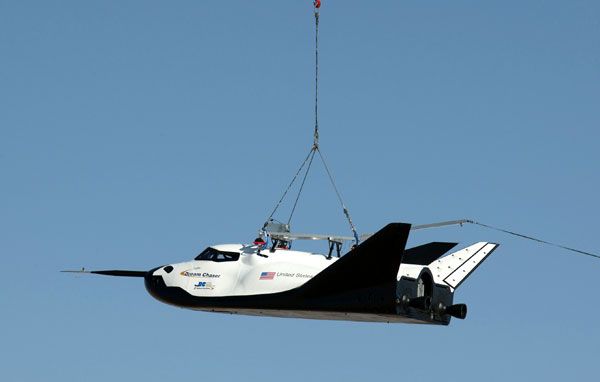 Sierra Nevada's Dream Chaser vehicle is hoisted into the air by an Erickson Air-Crane helicopter (not shown) during a captive-carry test conducted at NASA's Dryden Flight Research Center in California...on August 22, 2013. Sierra Nevada's Dream Chaser vehicle is hoisted into the air by an Erickson Air-Crane helicopter (not shown) during a captive-carry test conducted at NASA's Dryden Flight Research Center in California...on August 22, 2013.