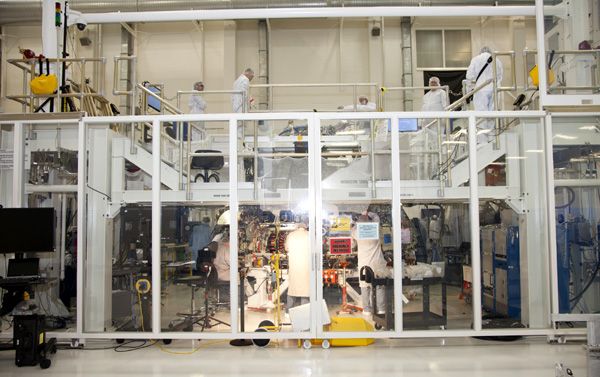 At NASA's Kennedy Space Center in Florida, technicians work on Orion’s crew module inside a temporary clean room at the Operations and Checkout facility. At NASA's Kennedy Space Center in Florida, technicians work on Orion’s crew module inside a temporary clean room at the Operations and Checkout facility.