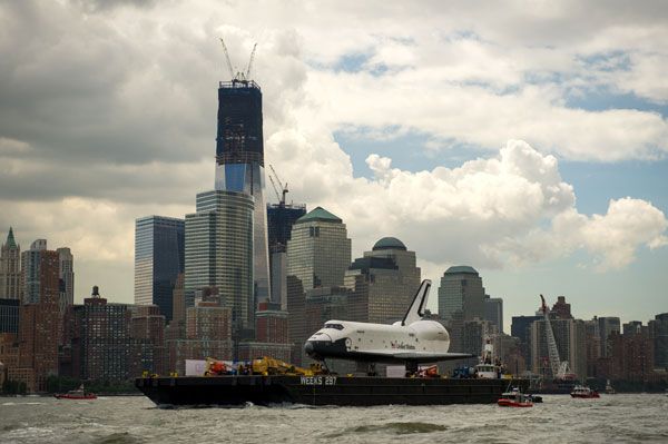 With the 1 World Trade Center in the background, the barge carrying Enterprise cruises along the Hudson River to the Intrepid Sea, Air and Space Museum in New York City, on June 6, 2012.