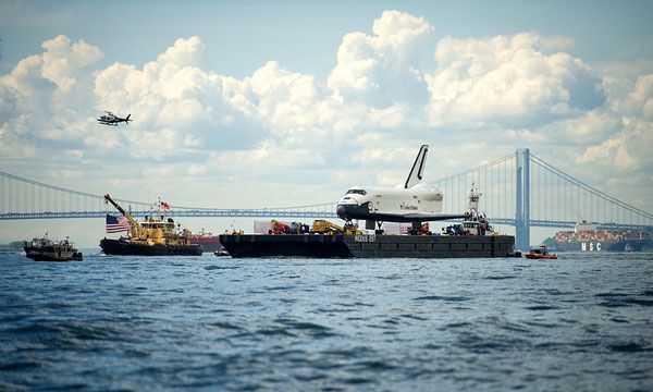 With the Verrazano-Narrows Bridge in the background, the barge carrying Enterprise cruises along the Hudson River to the Intrepid Sea, Air and Space Museum in New York City, on June 6, 2012.