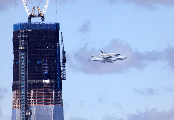 The shuttle Enterprise and NASA 905 fly near the 1 World Trade Center in New York City on April 27, 2012.