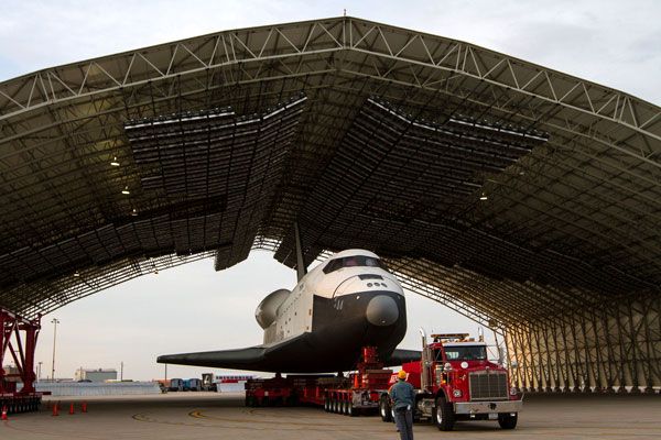 Enterprise is towed into a temporary hangar after being demated from NASA 905 at JFK International Airport, on May 12, 2012.