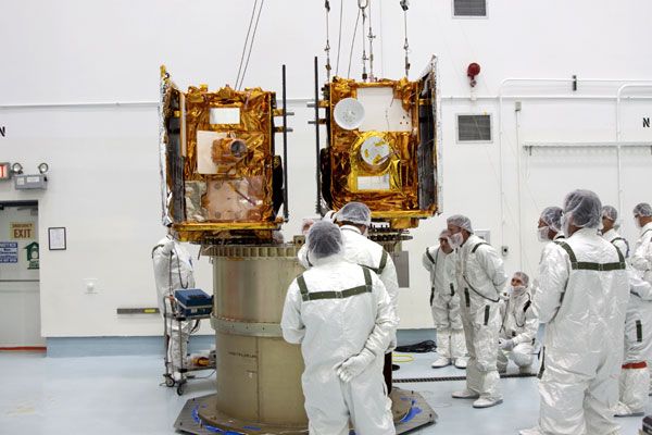 Technicians inspect the GRAIL spacecraft after they are attached to their adapter ring at the Astrotech Space Operations facility in Florida, on August 10, 2011.