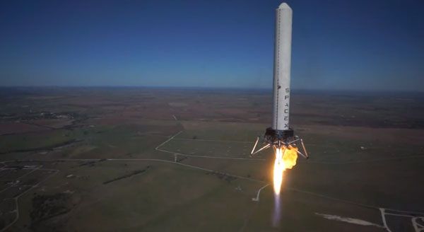 As the unmanned Hexacopter hovers nearby, the Grasshopper test vehicle begins to descend after reaching an altitude of 744 meters (2,441 feet) above McGregor, Texas, on October 7, 2013. As the unmanned Hexacopter hovers nearby, the Grasshopper test vehicle begins to descend after reaching an altitude of 744 meters (2,441 feet) above McGregor, Texas, on October 7, 2013.
