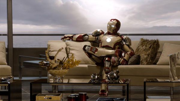 Still dressed in armor, Tony Stark (Robert Downey Jr.) kicks back on his couch in IRON MAN 3.