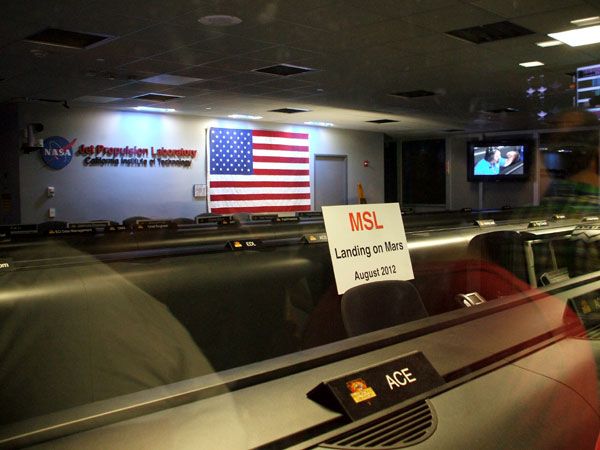 A sign posted inside the Space Flight Operations Facility reminds Open House visitors of the Curiosity rover's landing on Mars this August 5.