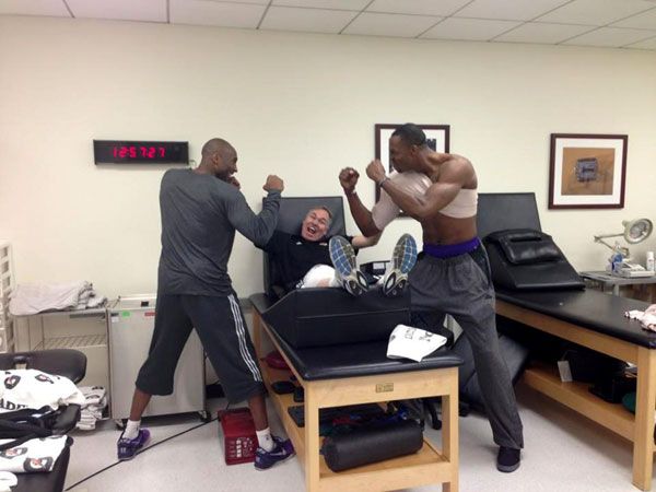 Kobe Bryant and Dwight Howard pretend to brawl as Lakers coach Mike D'Antoni um, looks on.