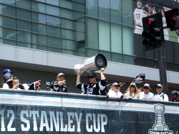 The Stanley Cup trophy is hoisted into the air for the crowd to see during the Kings' championship parade in downtown L.A., on June 14, 2012.