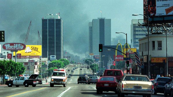 In the distance, Koreatown is enshrouded in smoke during the 1992 Los Angeles riots.