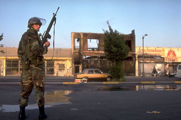 A U.S. Marine Corps soldier patrols Crenshaw during the 1992 Los Angeles riots.