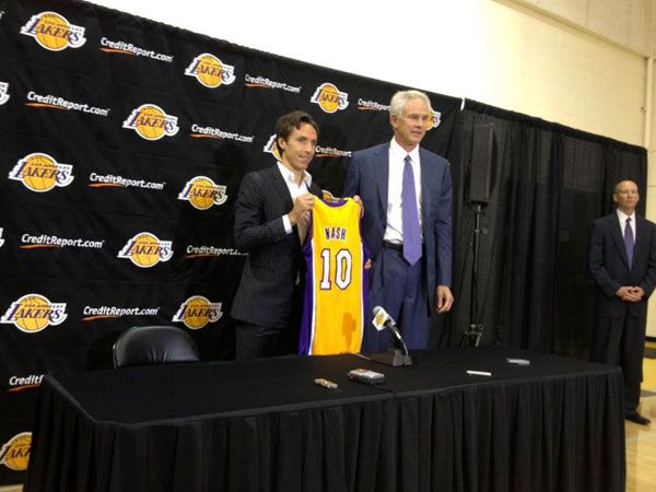 With Lakers General Manager Mitch Kupchak standing nearby, Steve Nash presents the jersey that he's going to wear for the next 3 NBA seasons.