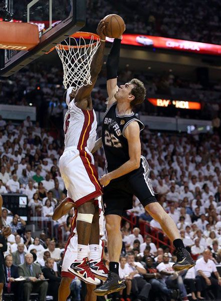 LeBron James blocks a dunk attempted by Tiago Splitter during the Miami Heat's Game 2 victory against the San Antonio Spurs on June 9, 2013.