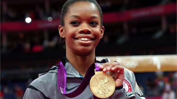 Gabrielle Douglas poses with her gold medal after winning the women's Individual All-Around in gymnastics on August 2, 2012.