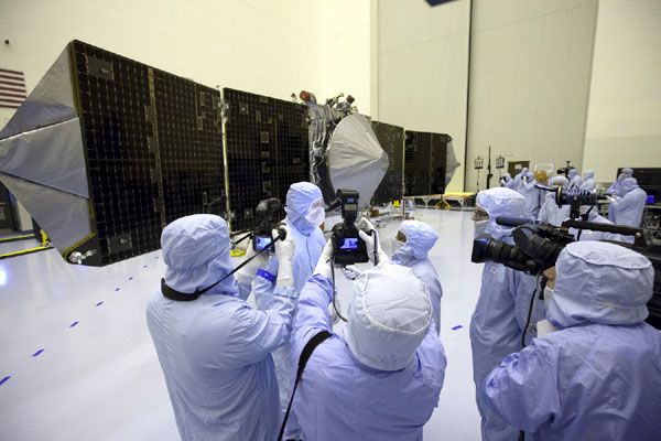 Reporters and photographers gather in front of NASA's MAVEN spacecraft as it was put on display for the media to see at the Kennedy Space Center in Florida, on September 27, 2013.