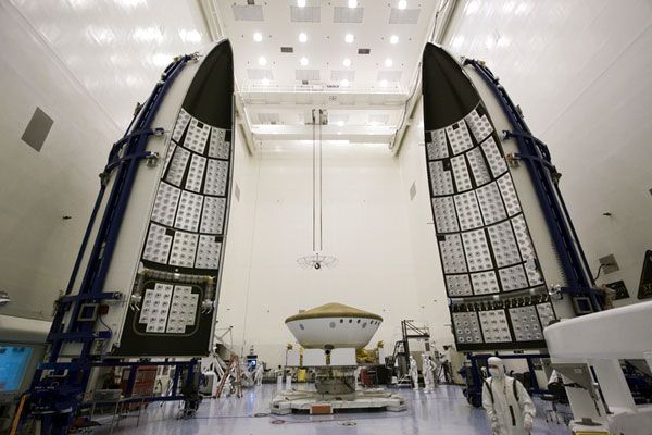 The Curiosity Mars rover, now encased inside its aeroshell, is about to be encapsulated by its Atlas V payload fairing on October 25, 2011.