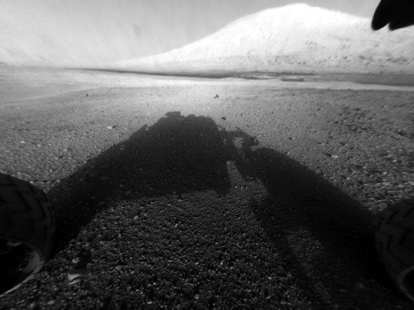 An image of Curiosity's shadow with Mount Sharp in the background...taken by one of the rover's hazard-avoidance cameras on August 5, 2012.