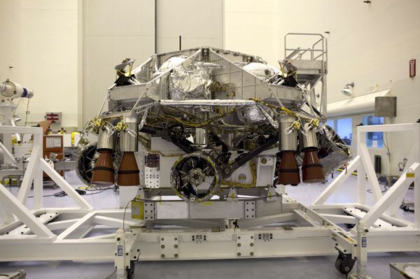 The Curiosity Mars rover and its descent stage prior to being enclosed by the backshell at NASA's Kennedy Space Center in Florida.