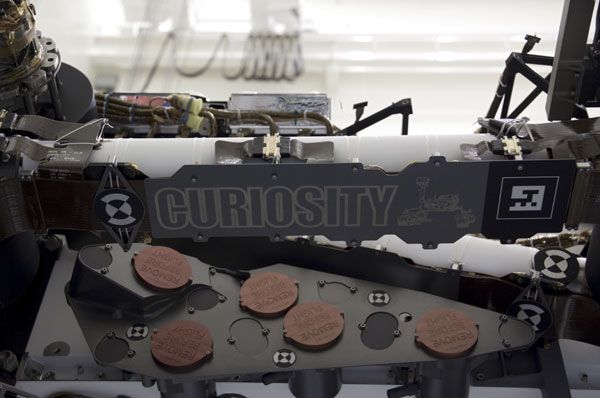 A name fixture is attached to the Curiosity Mars rover at NASA's Kennedy Space Center in Florida.
