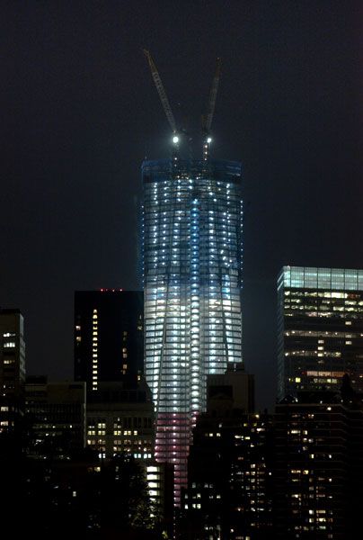 The 1 World Trade Center, due to be completed in 2013, shines under red, white and blue lights to commemorate the 10-year anniversary of the September 11 attacks.