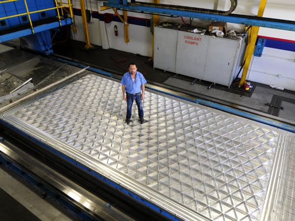 A technician stands on the first test panel for the Space Launch System's liquid hydrogen fuel tank at AMRO Fabricating Corporation in South El Monte, California. A technician stands on the first test panel for the Space Launch System's liquid hydrogen fuel tank at AMRO Fabricating Corporation in South El Monte, California.