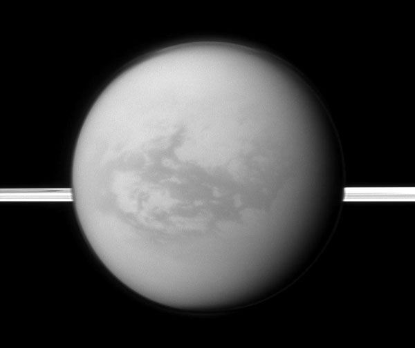Saturn's rings lie in the distance as the Cassini spacecraft looks toward Titan and its dark region dubbed Shangri-La, on August 9, 2011.