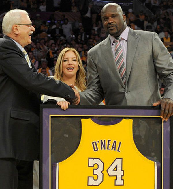 As Jeanie Buss looks on, former Lakers coach Phil Jackson congratulates Shaquille O'Neal during his jersey retirement ceremony at STAPLES Center in Los Angeles, on April 2, 2013.