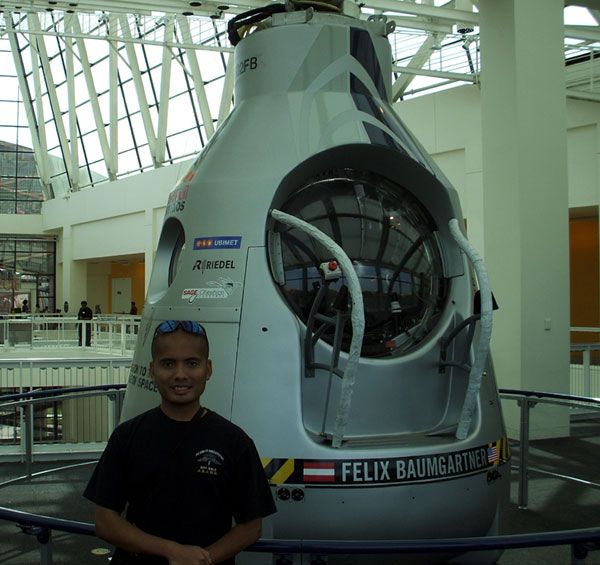 Posing with the Red Bull Stratos capsule used for Felix Baumgartner's historic space jump, on October 13, 2013.