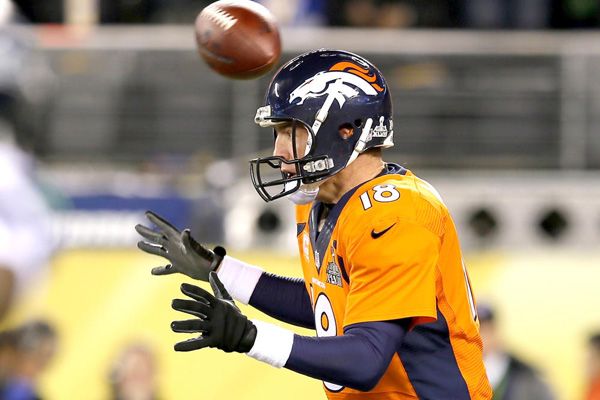 The football flies above Peyton Manning's head as the Denver Broncos err on the first play of Super Bowl XLVIII, on February 2, 2014.