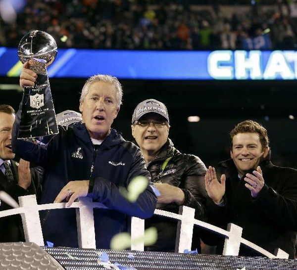 Seattle Seahawks coach Pete Carroll hoists up the Vince Lombardi Trophy after his team defeated the Denver Broncos, 43-8, in Super Bowl XLVIII...on February 2, 2014.