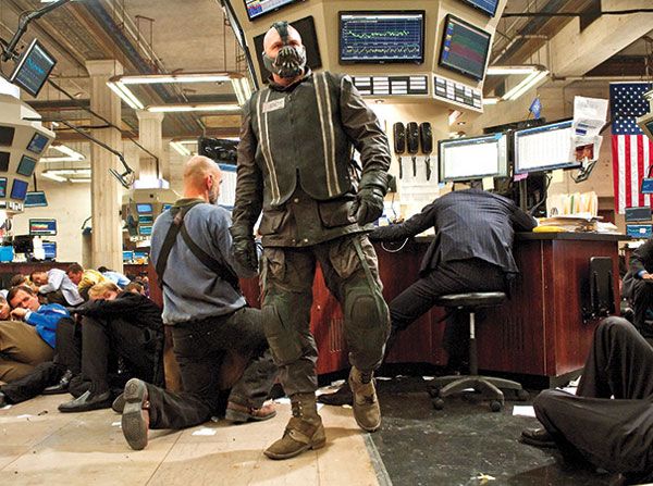 Bane (Tom Hardy) wreaks havoc on Wall Street in THE DARK KNIGHT RISES.