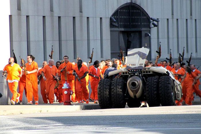 Dozens of inmates who broke out of prison approach the Tumbler in THE DARK KNIGHT RISES.
