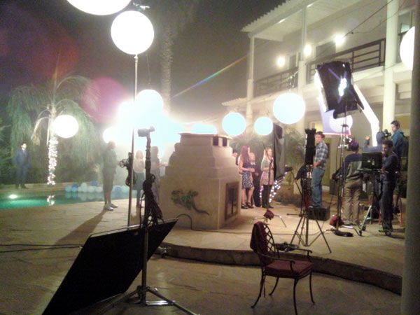 Filming a dinner party scene on the mansion's rear patio.