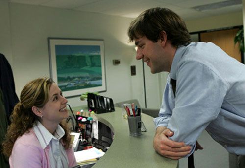 Jim Halpert hangs out at Pam Beasley's reception desk to chat with her in THE OFFICE.