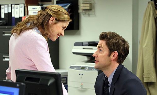 Pam Beasley hangs out at Jim Halpert's desk to chat with him in THE OFFICE.