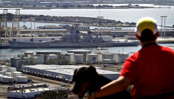 A Bay Area resident views the USS Iowa from an overlook. 