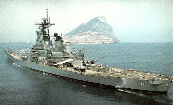 An archival photo of the USS Iowa sailing near the Rock of Gibraltar in the Mediterranean.