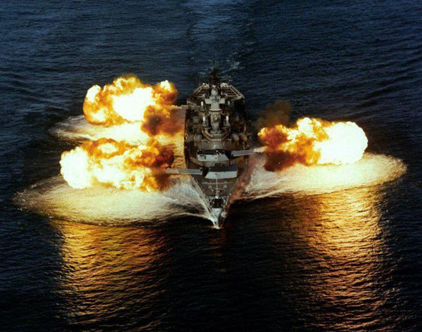 The USS Iowa fires from all three of her 16-inch gun turrets.