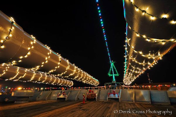 Three of the USS Iowa's forward 16-inch guns are adorned in Christmas lights.