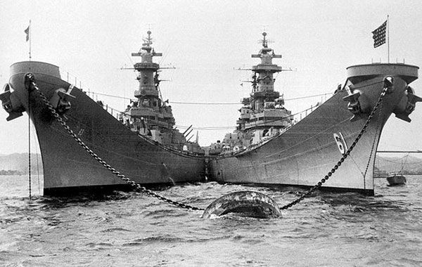 The USS Missouri (BB-63, left) is docked alongside her sister ship USS Iowa (BB-61, right) in this World War II-era photo.
