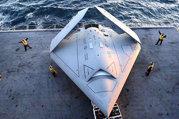 An elevator is about to take the X-47B UCAV up to the flight deck of the USS George H.W. Bush for its first catapult launch, on May 14, 2013.