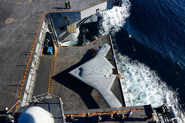 An elevator is about to take the X-47B UCAV up to the flight deck of the USS George H.W. Bush for its first catapult launch, on May 14, 2013.