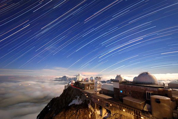A time-lapse shot showing stars moving across the sky above the Pic du Midi Observatory.