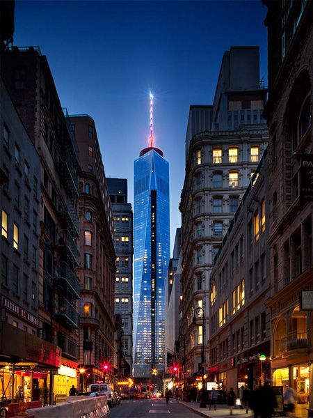 Under the night sky, the 1 World Trade Center's (1 WTC) antenna spire glows above New York City.