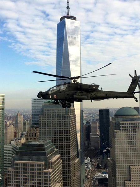 An AH-64 Apache attack helicopter flies past the 1 WTC in New York City.