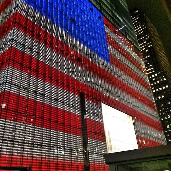 The glass panels enshrouding 1 WTC's base structure glow in patriotic colors on October 23, 2014.