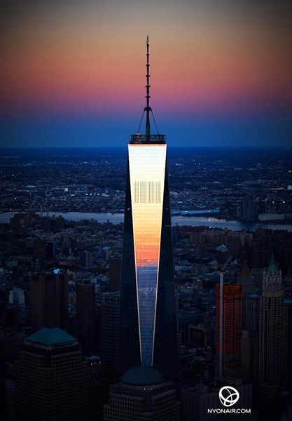 The Sun reflects off of the 1 World Trade Center's (1 WTC) shiny facade, on October 13, 2014.