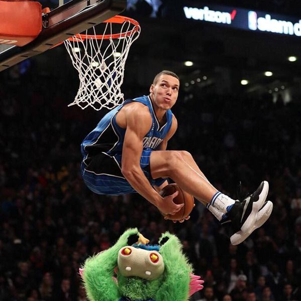 The Orlando Magic's Aaron Gordon leaps over team mascot Stuff the Magic Dragon during the 2016 NBA Slam Dunk Contest...on February 13, 2016.