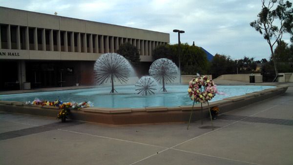 A wreath and flowers are placed near the Lyman Lough fountain at CSULB's Brotman Hall...in honor of Nohemi Gonzalez on November 15, 2015.