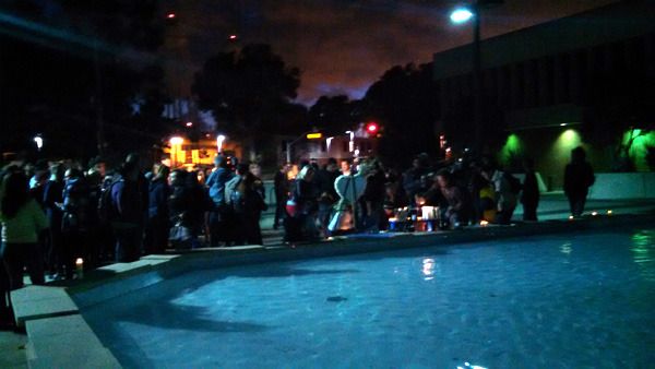 Dozens of people lay flowers, candles and other items near the Lyman Lough fountain at CSULB's Brotman Hall...in honor of Nohemi Gonzalez on November 15, 2015.