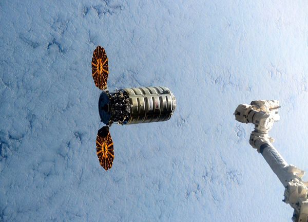 Cygnus Orb-4 (also known as the 'S.S. Deke Slayton II') floats near the ISS as its robotic arm waits to grapple the cargo freighter on December 9, 2015. Cygnus Orb-4 (also known as the 'S.S. Deke Slayton II') floats near the ISS as its robotic arm waits to grapple the cargo freighter on December 9, 2015.